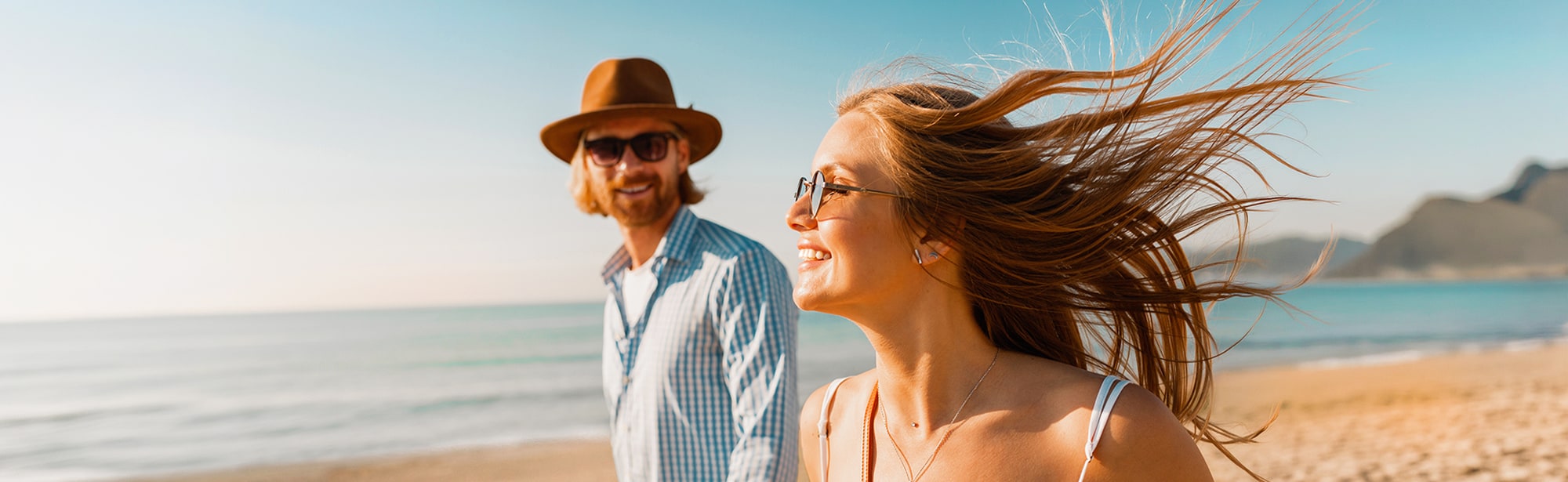 Young couple smiling outside